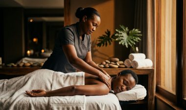 A therapist massages a client's shoulders in a calm Nairobi spa.